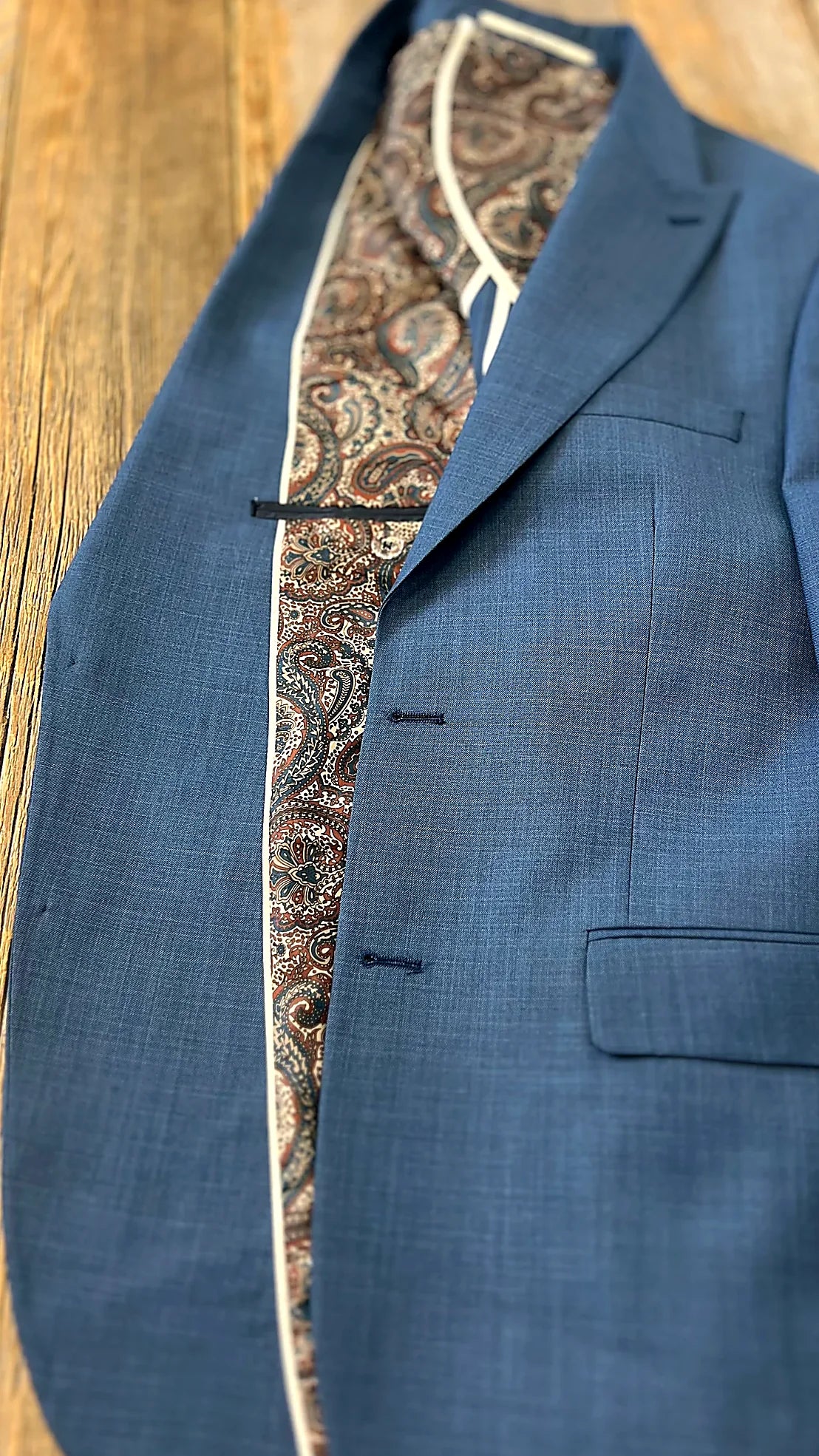 textured blue cloth with structured shoulders