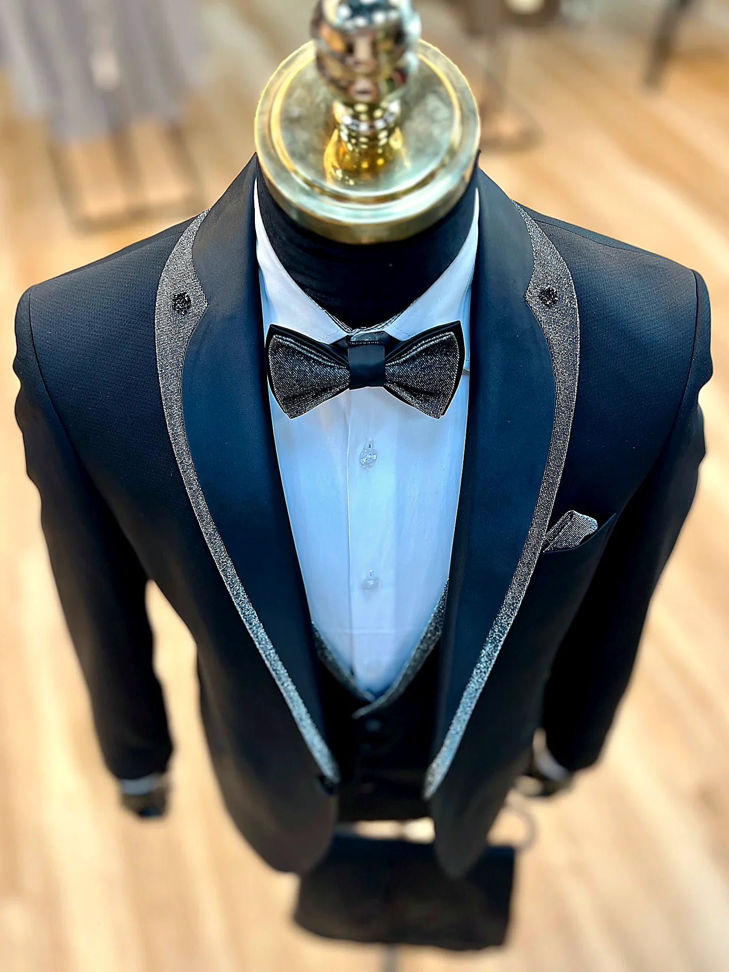 Evening Tuxedo featuring a sleek shawl lapel adorned with a striking shiny red trim.g
