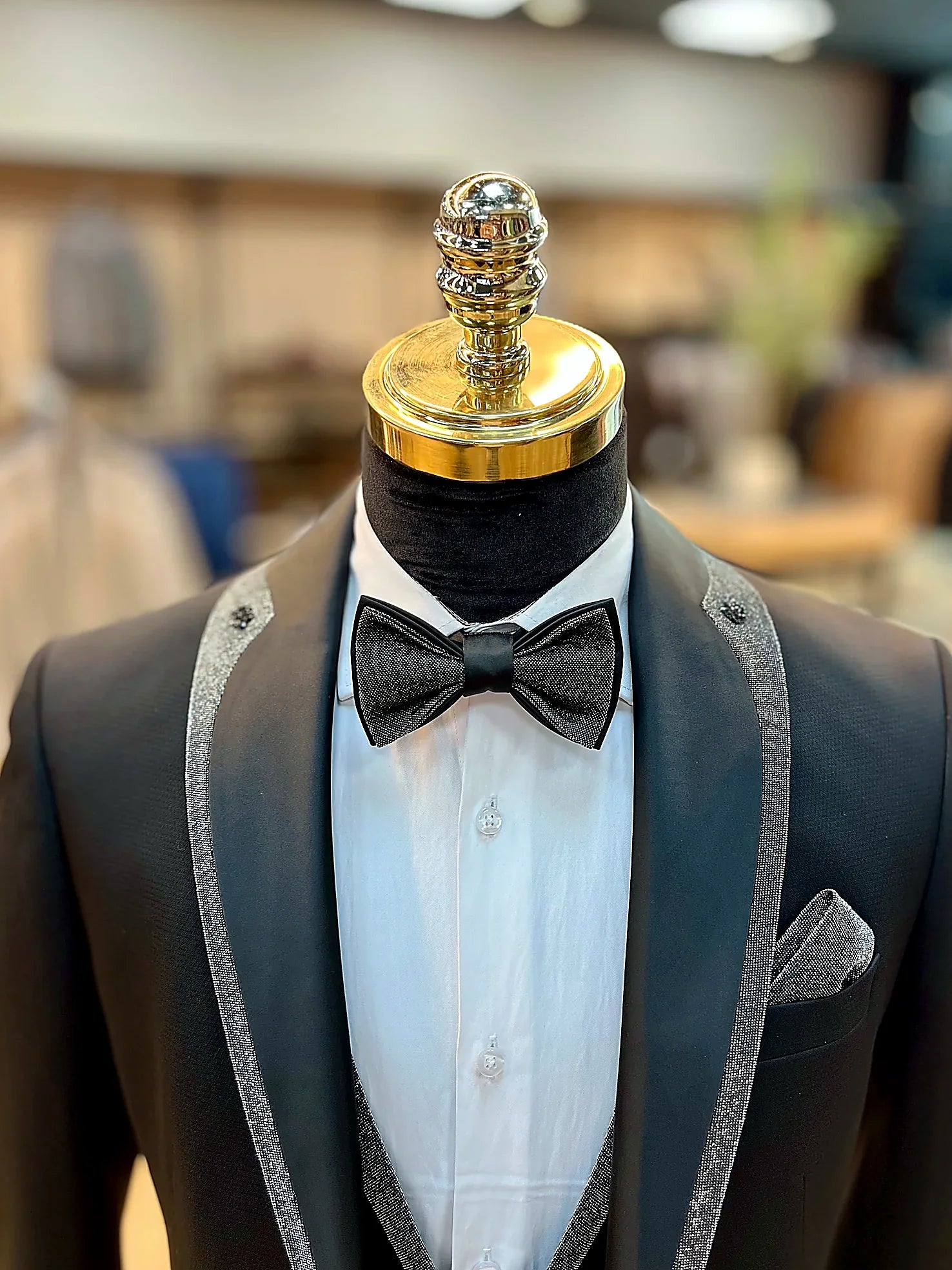 Evening Tuxedo featuring a sleek shawl lapel adorned with a striking shiny red trim.g