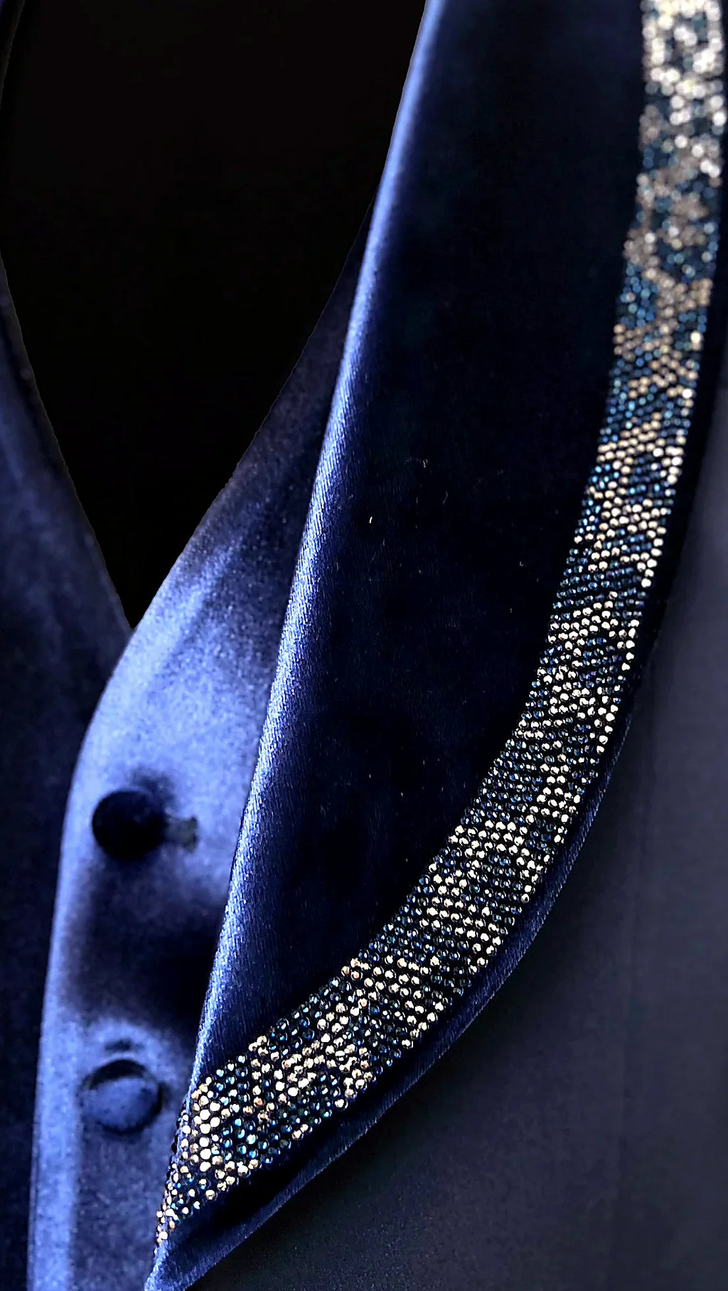 hand-applied crystals catching light along a velvet shawl lapel, on this deep Blue Velvet Tuxedo