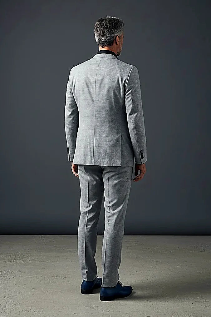 a paisley-patterned lining behind a sleek gray jacket