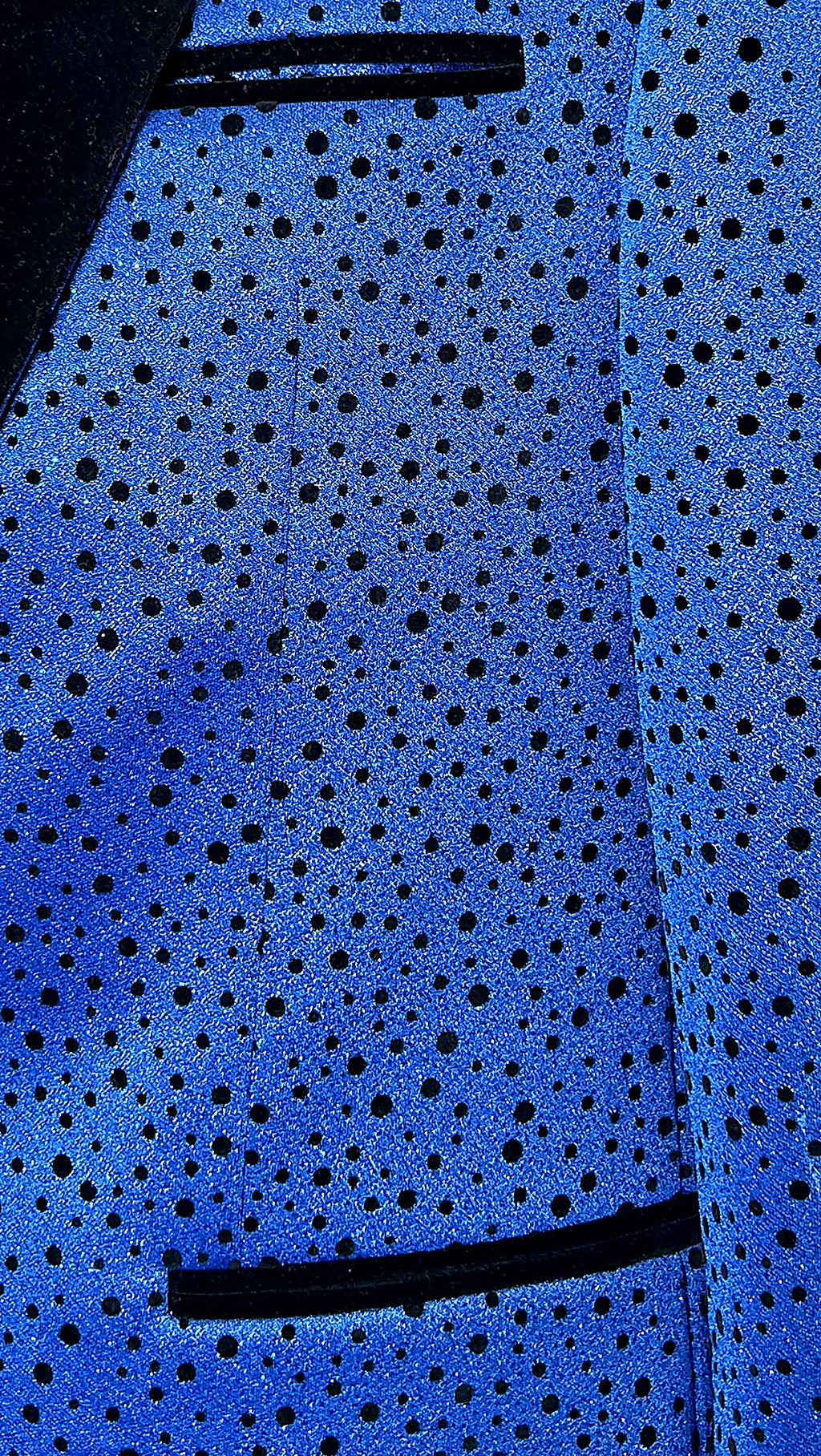 a velvet peak lapel above a playful polka-dot ground