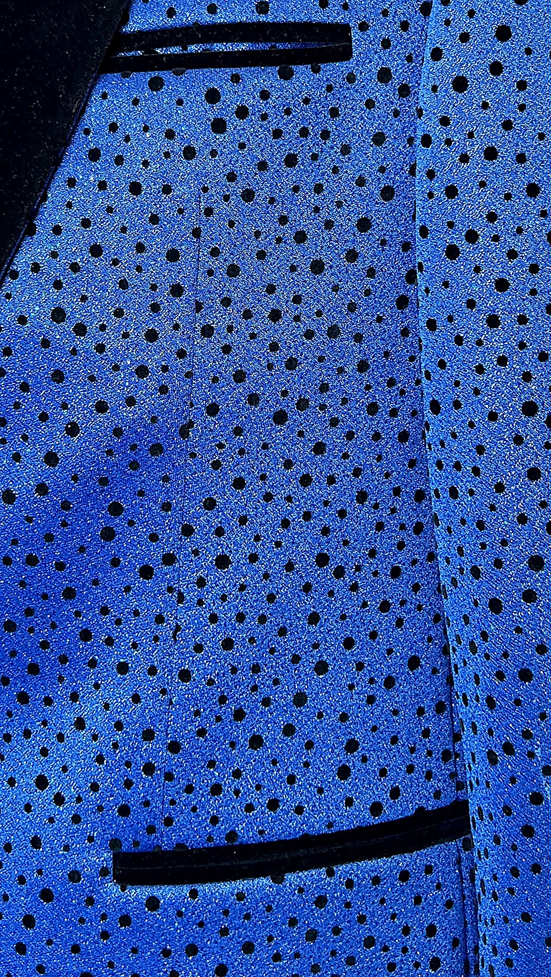 a velvet peak lapel above a playful polka-dot ground