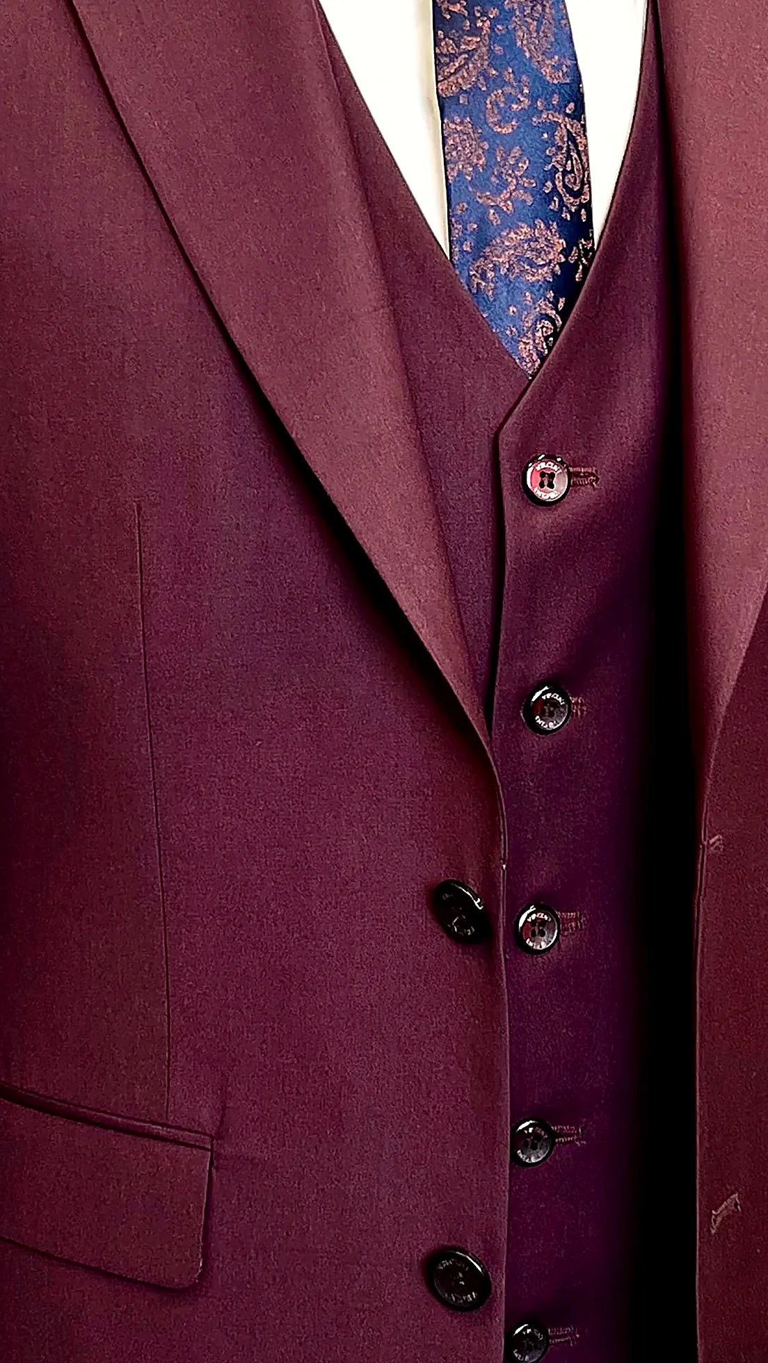 an intricately patterned lining inside deep burgundy cloth